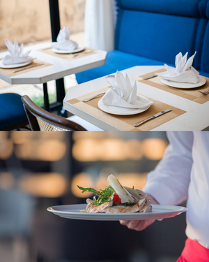 Eingedeckter Tisch und Servicekraft, die Essen serviert
